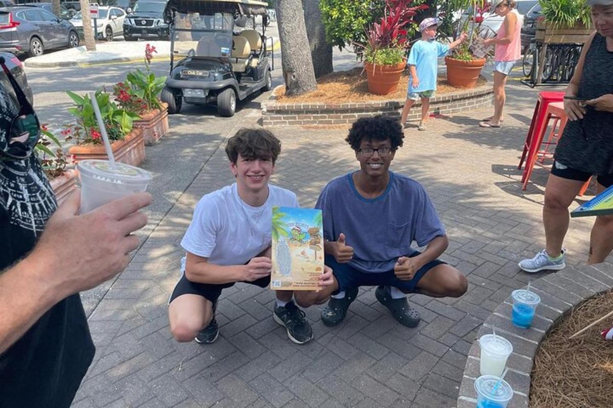 two young men sitting on the ground holding a gift