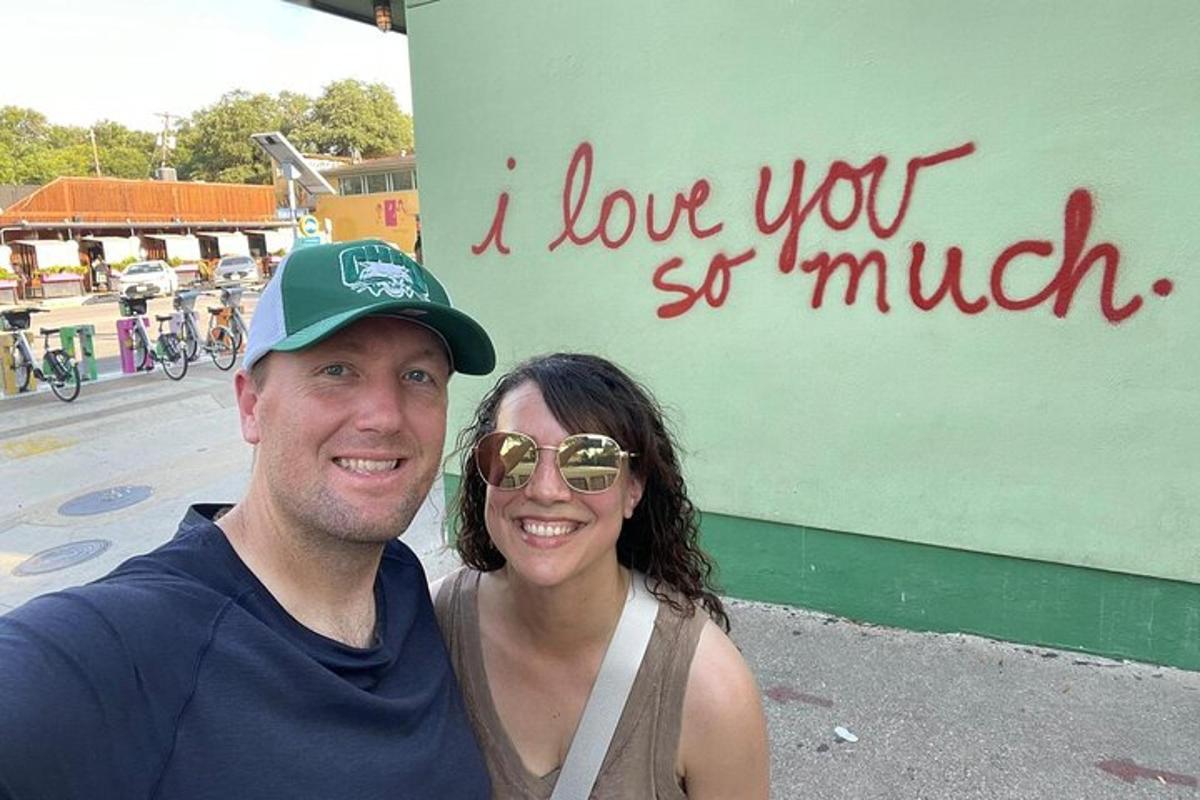 a man and a woman standing in front of a sign