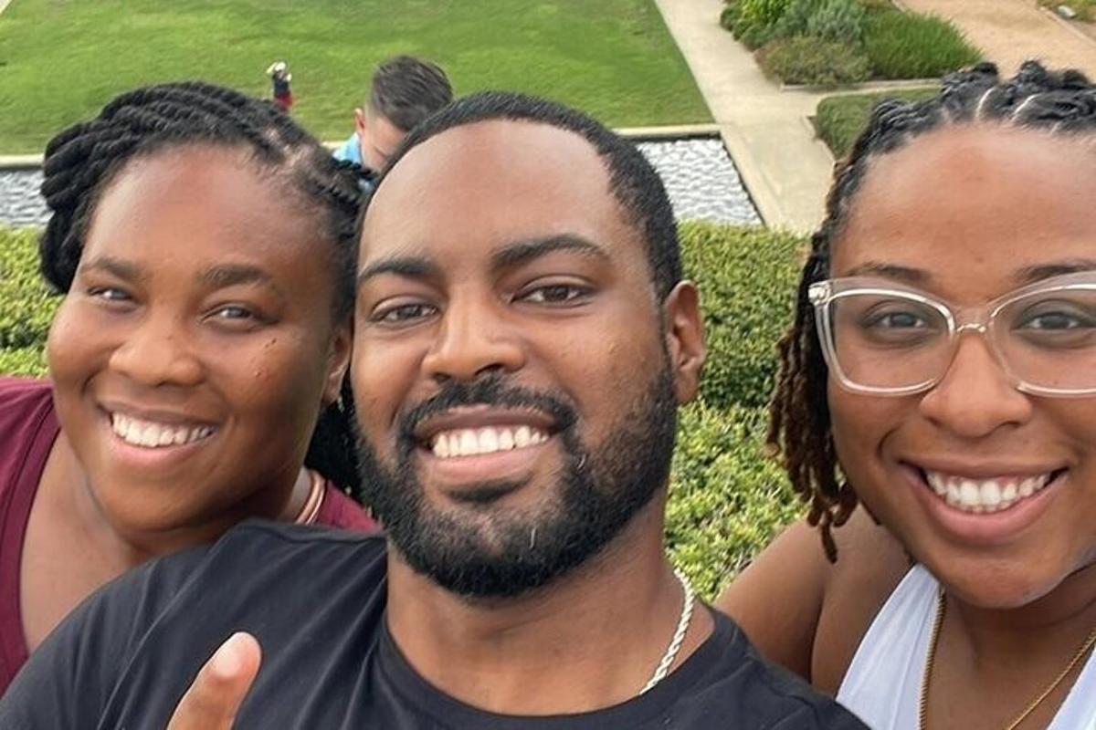 a group of three people posing for a picture