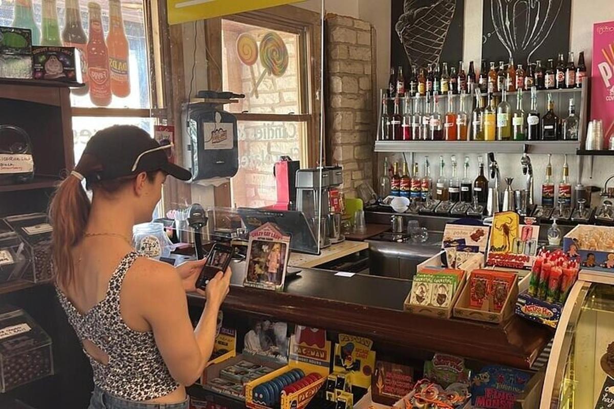 a woman standing at the counter of a bar