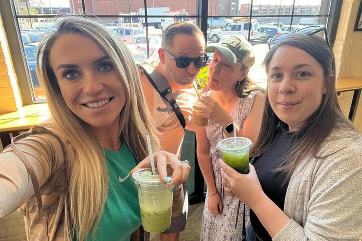 a group of people posing for a picture with drinks