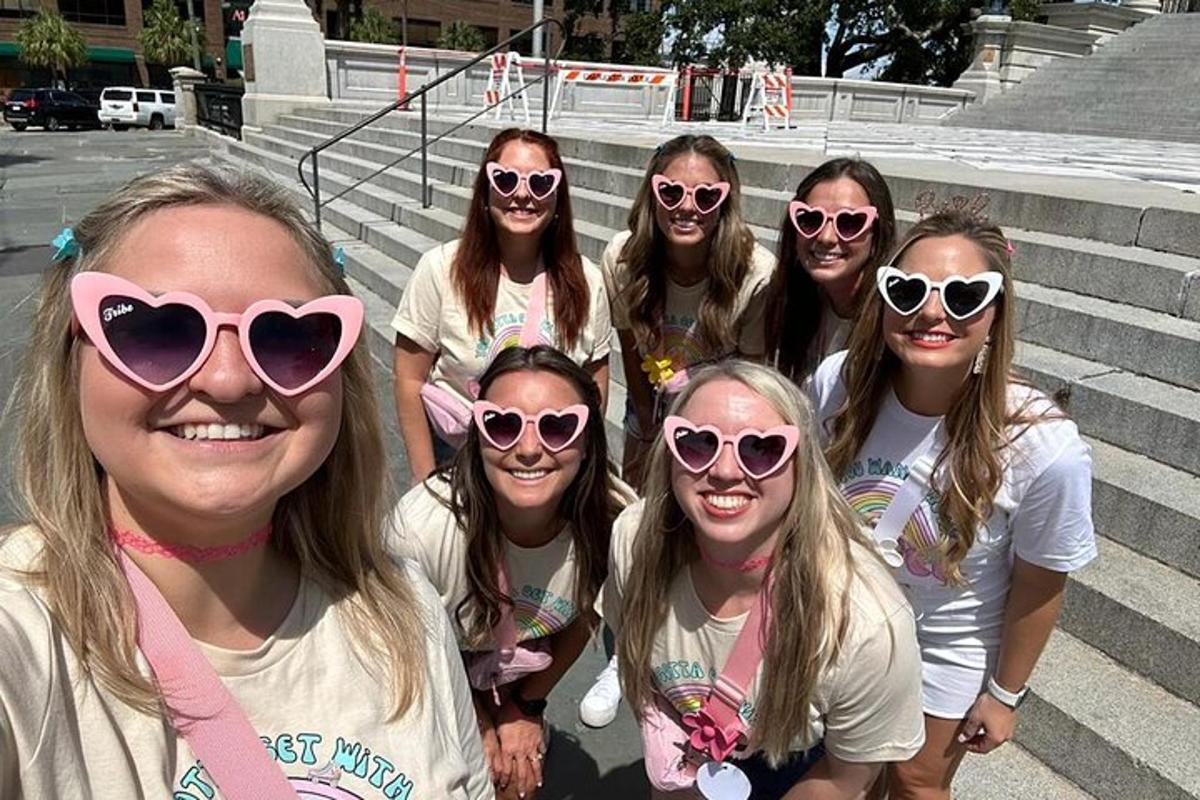 a group of girls in sunglasses posing for a picture