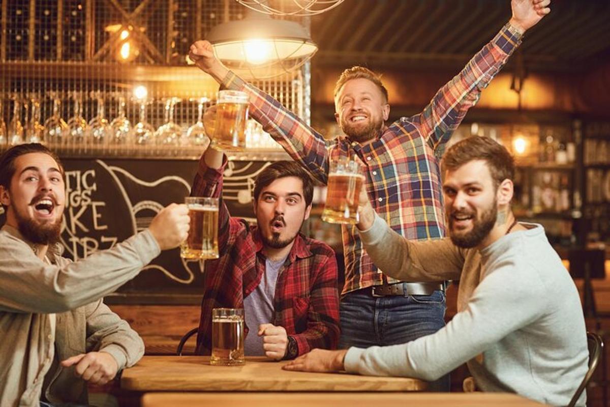 vīriešu grupa, kas dzer alu bārā