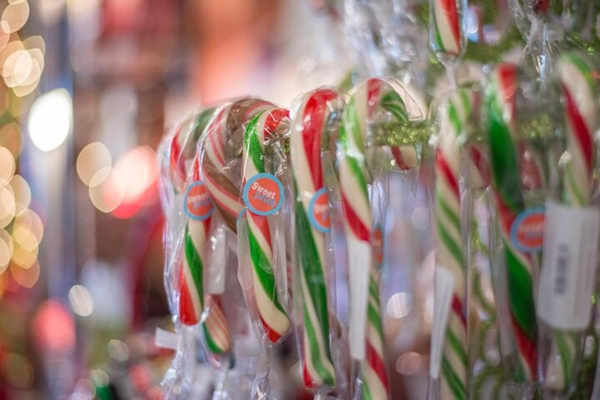 a row of wine glasses filled with candy canes