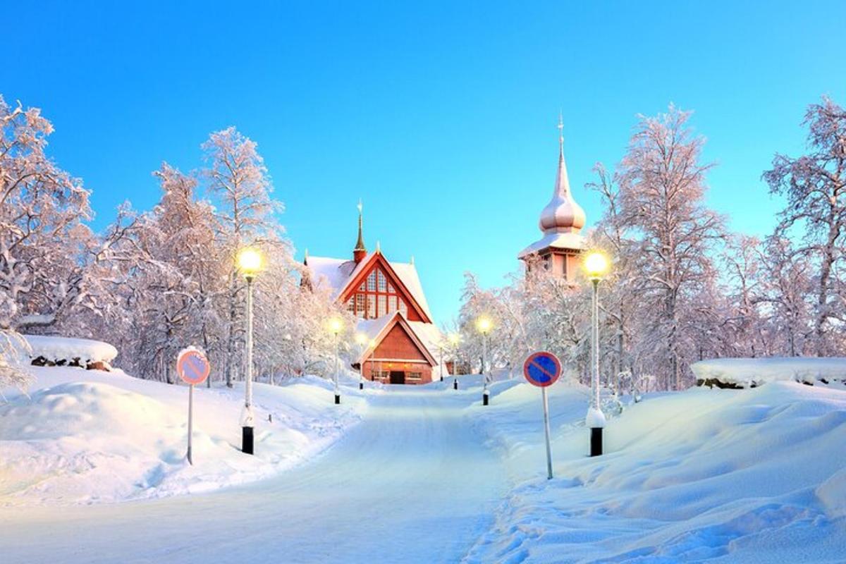 a snow covered road in front of a church