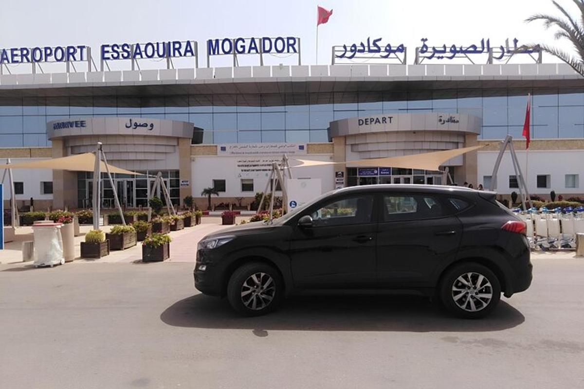 a black car parked in front of a hospital