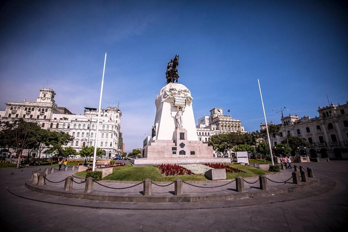 a statue in the middle of a city with buildings