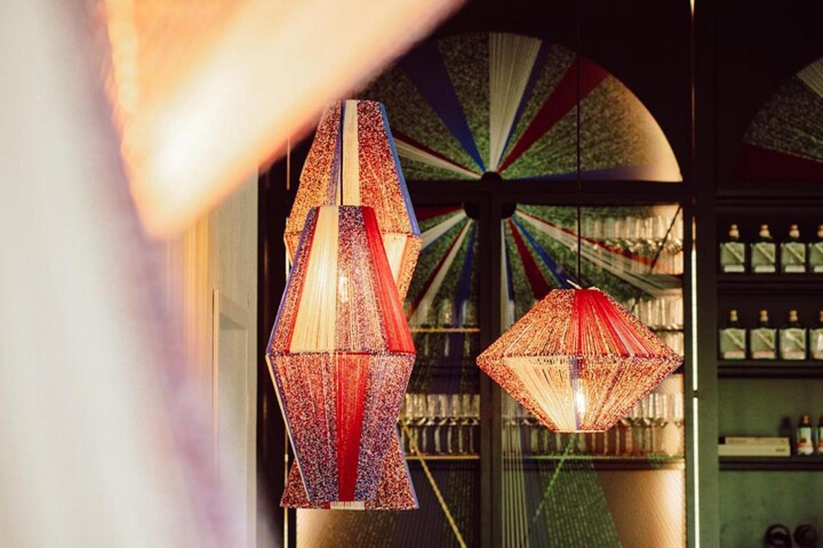 two colorful lights are hanging from a wall