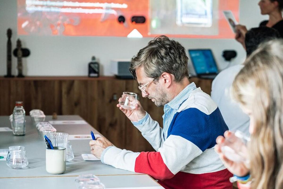 a man sitting at a table with a woman holding a glass