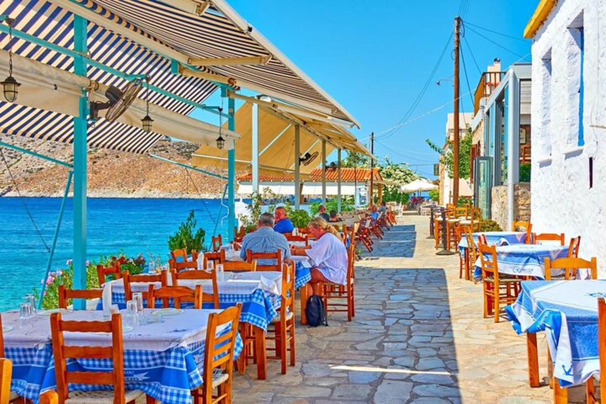 a group of people sitting at tables at an outdoor restaurant