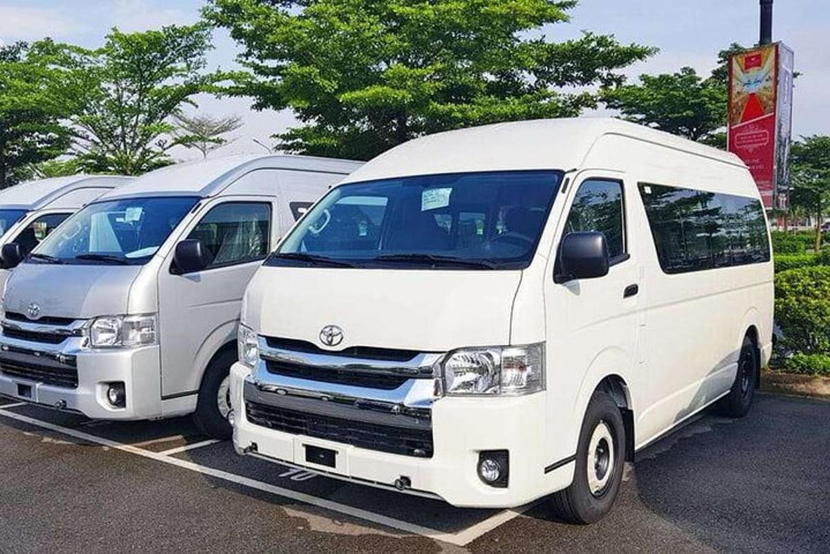 a row of white vans parked in a parking lot