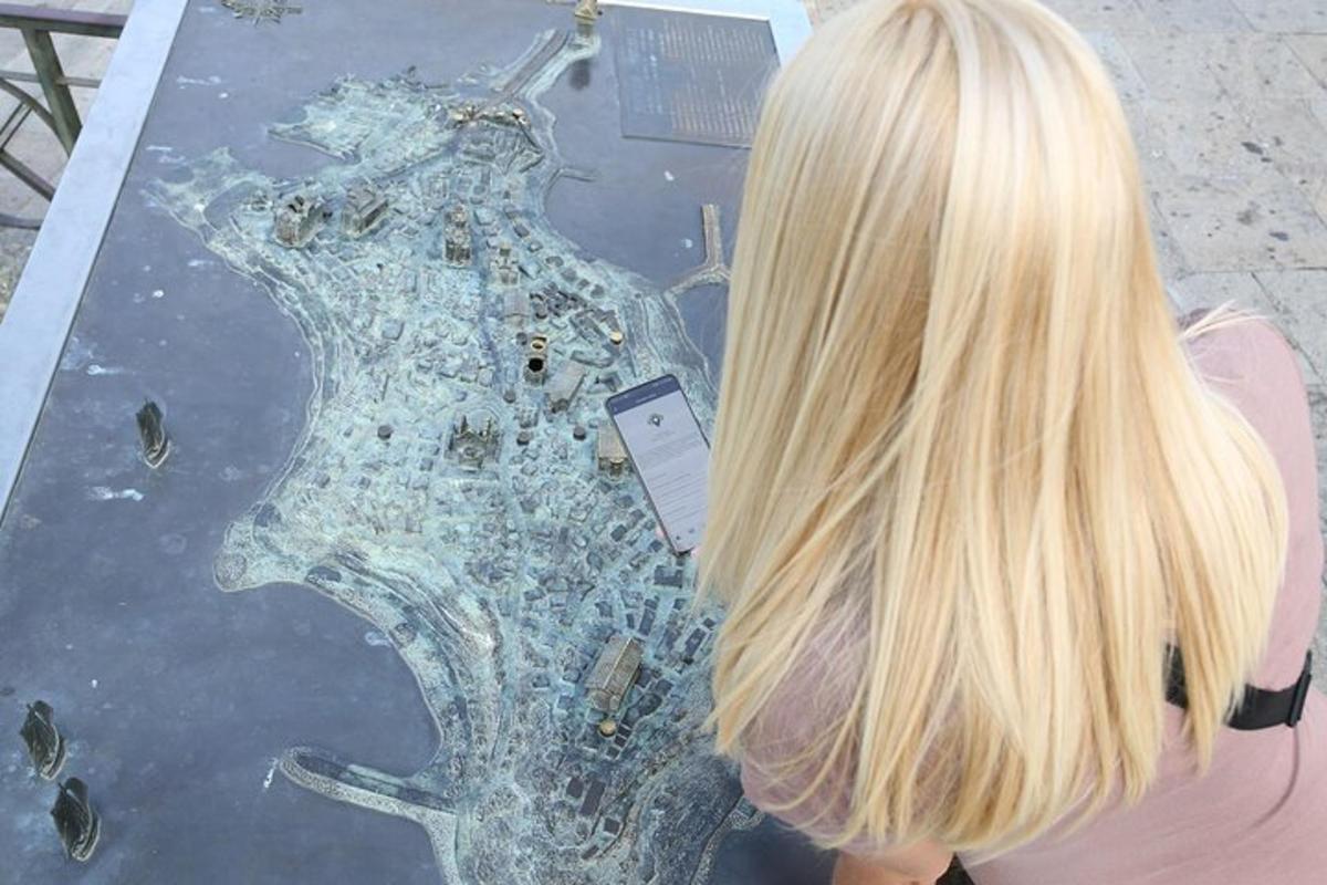 a woman with blonde hair looking at a glass table