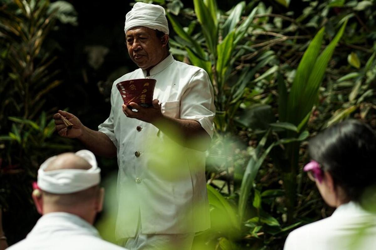 a man in a chefs outfit holding a book