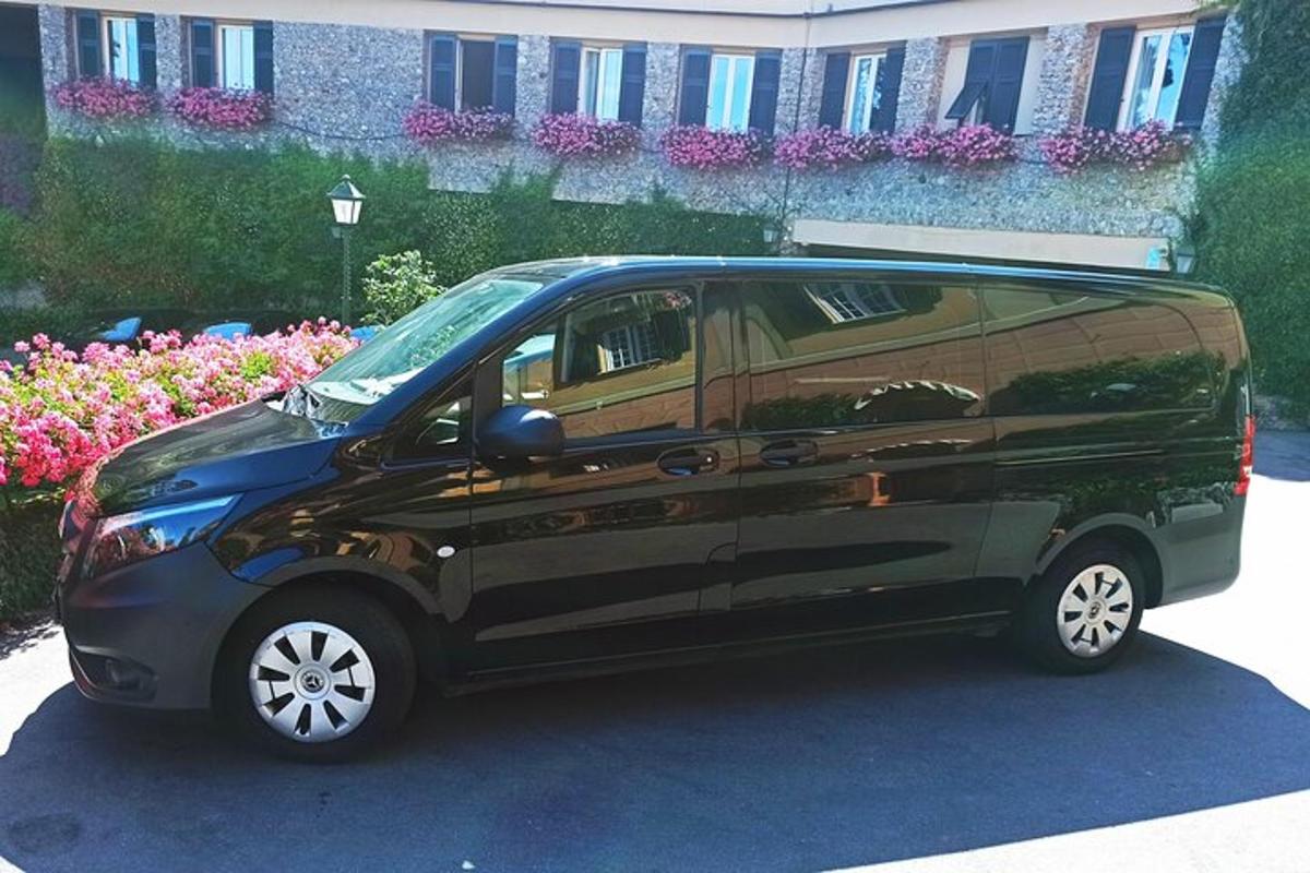 Una camioneta negra estacionada en un estacionamiento con flores.