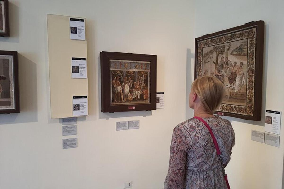 a woman looking at a painting on a wall