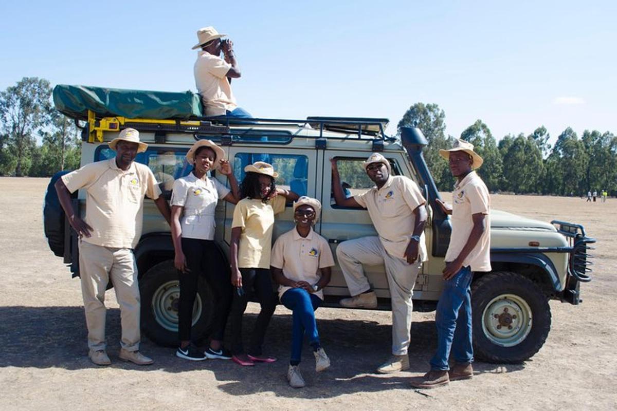 a group of people standing in front of a vehicle