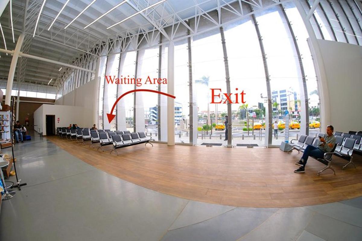 a person sitting in a chair in a waiting area of a building