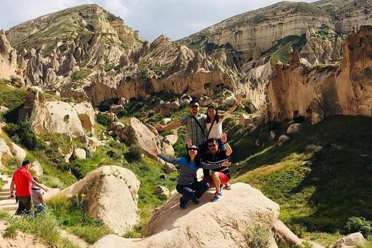 a group of people posing on top of a mountain