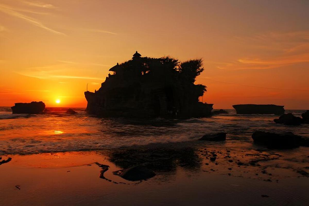 un'isola nell'oceano con il tramonto sullo sfondo