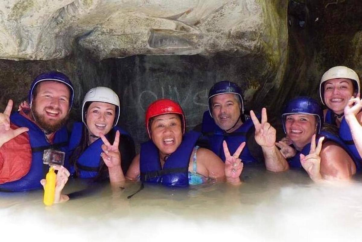 a group of people in the water in a cave