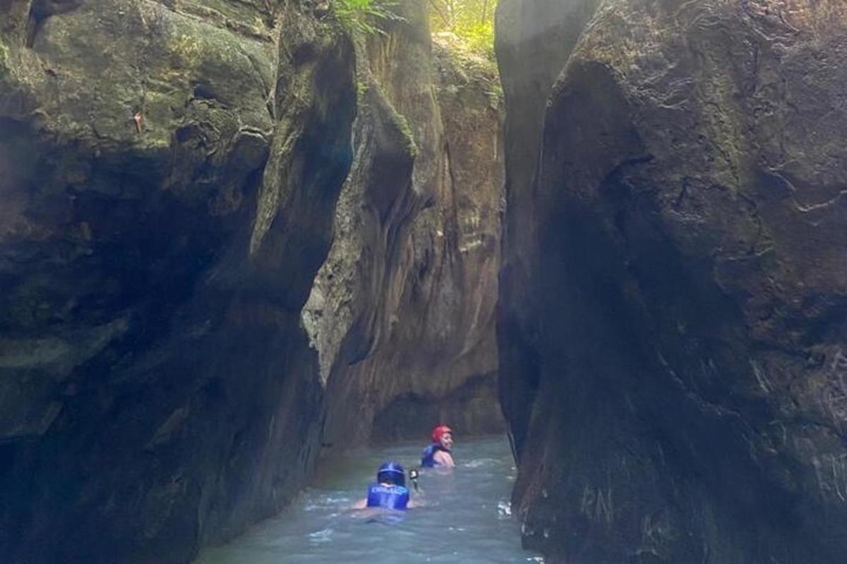 a group of people in a river in a cave