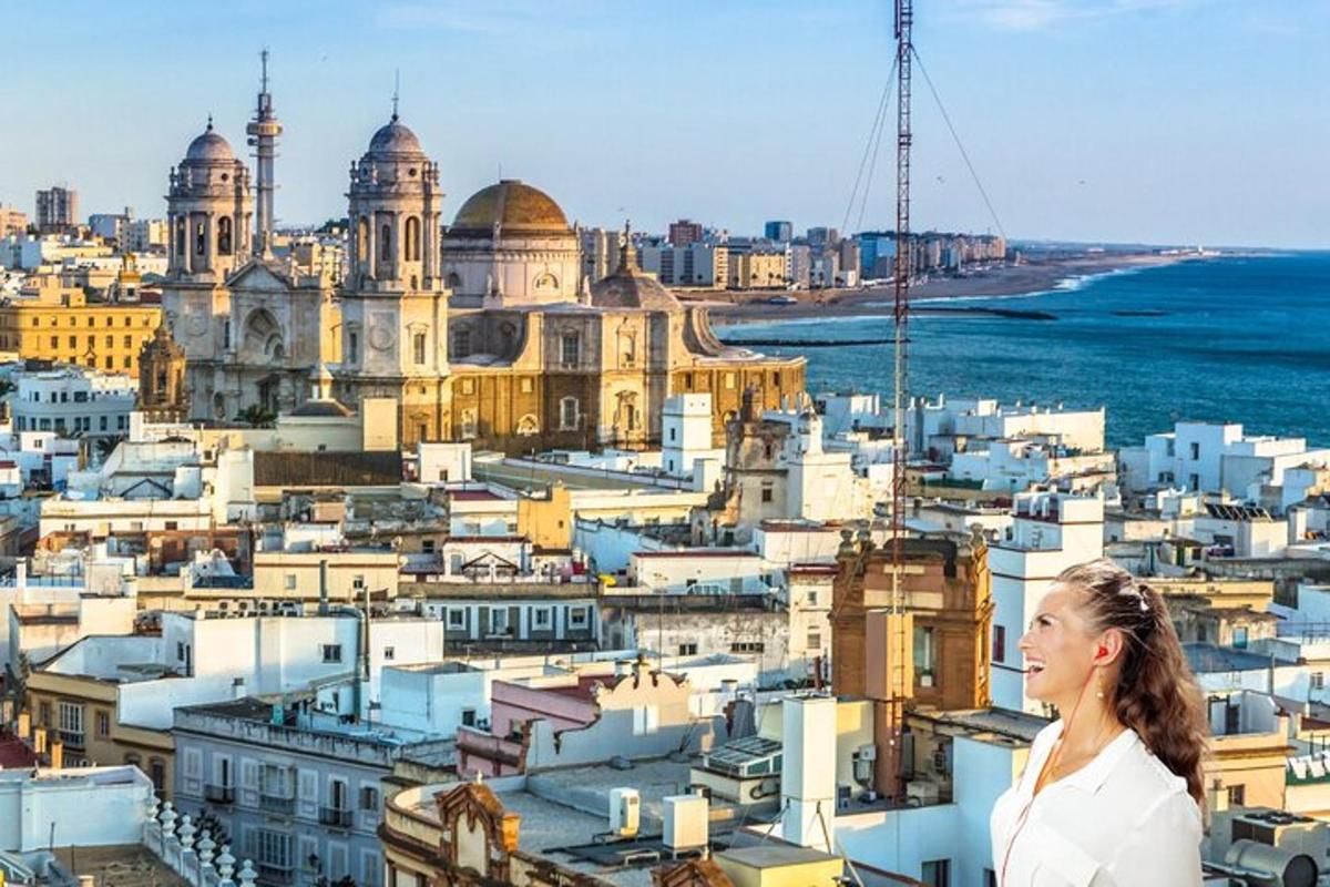 a woman standing on a ledge overlooking a city