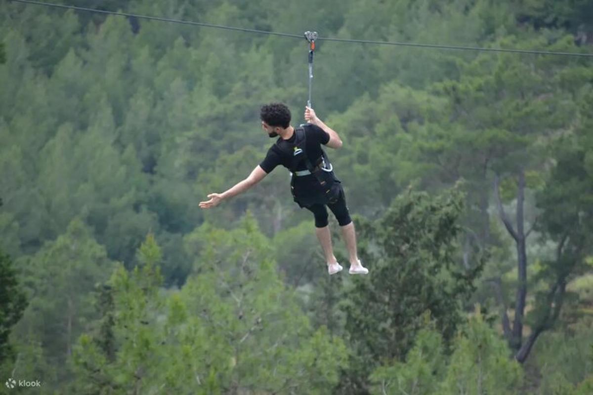 a man on a zip line in the air