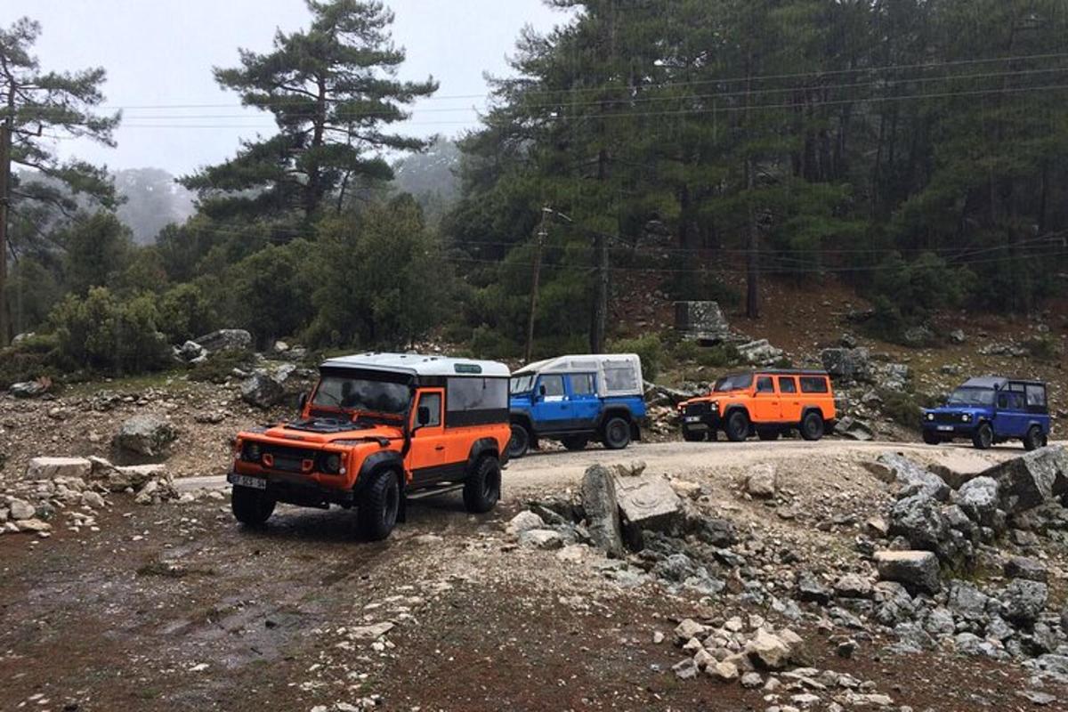 a group of trucks parked on a dirt road