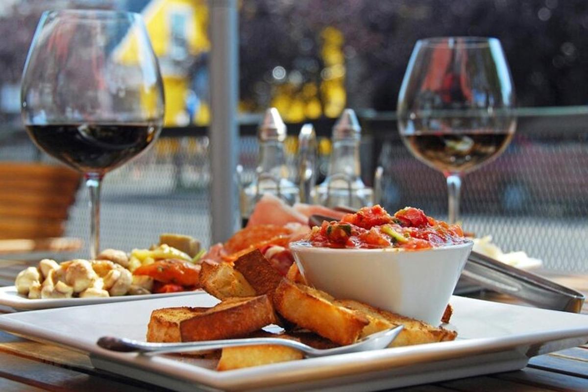 a plate of food and two glasses of wine