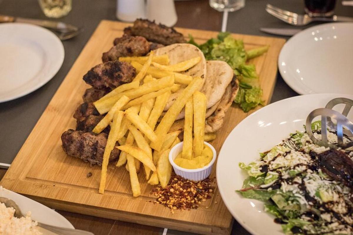 a wooden cutting board with french fries and hamburgers