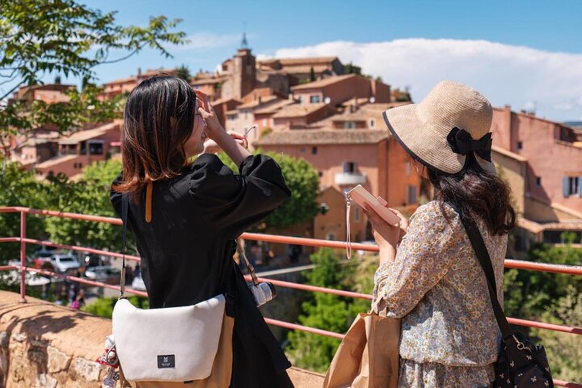 two women are looking at a city from a ledge