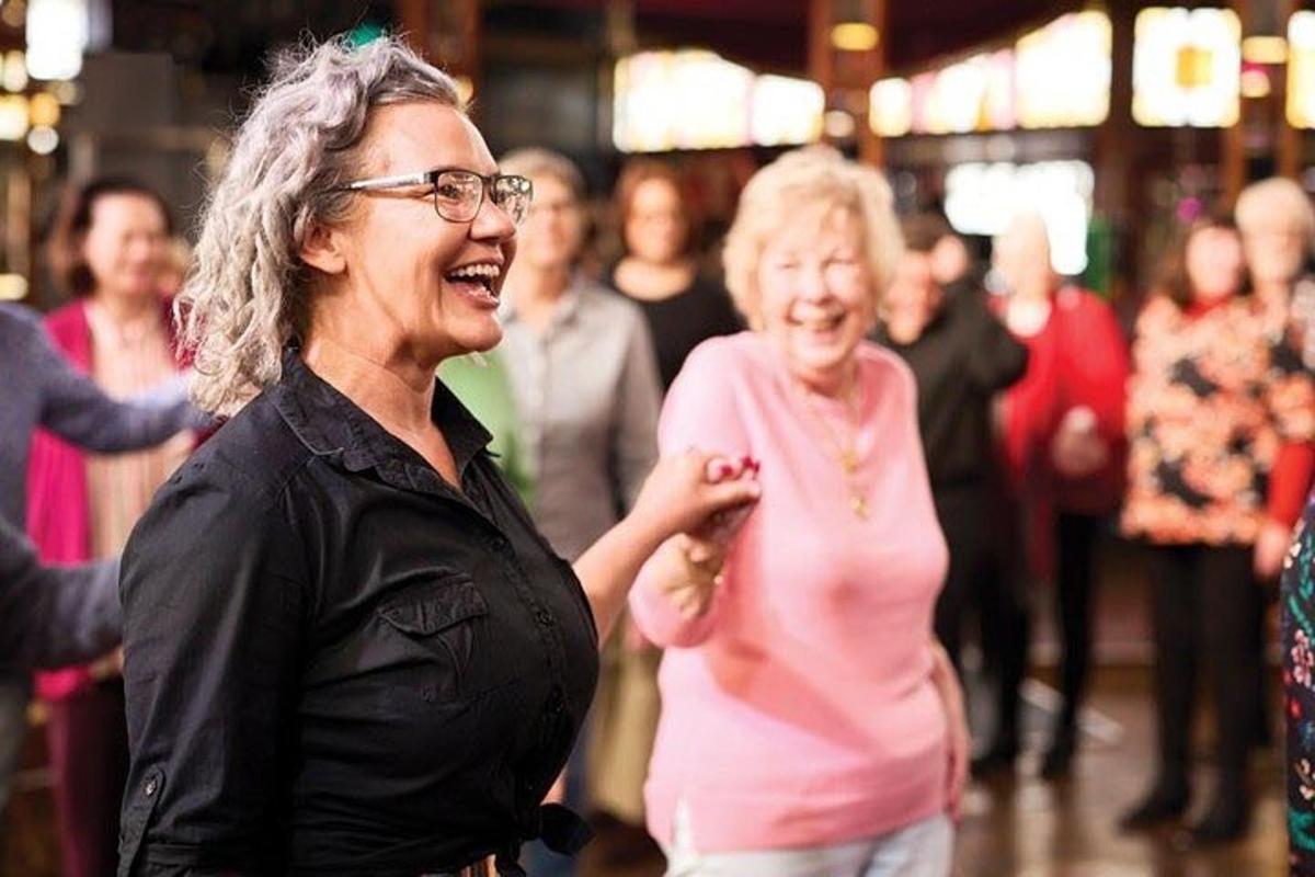 a group of people dancing on a dance floor