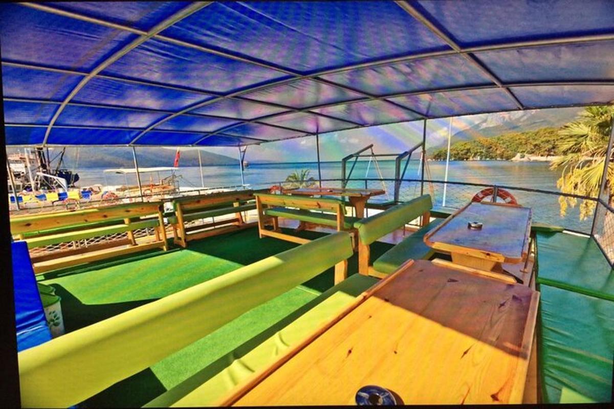 a boat with tables and benches on the water