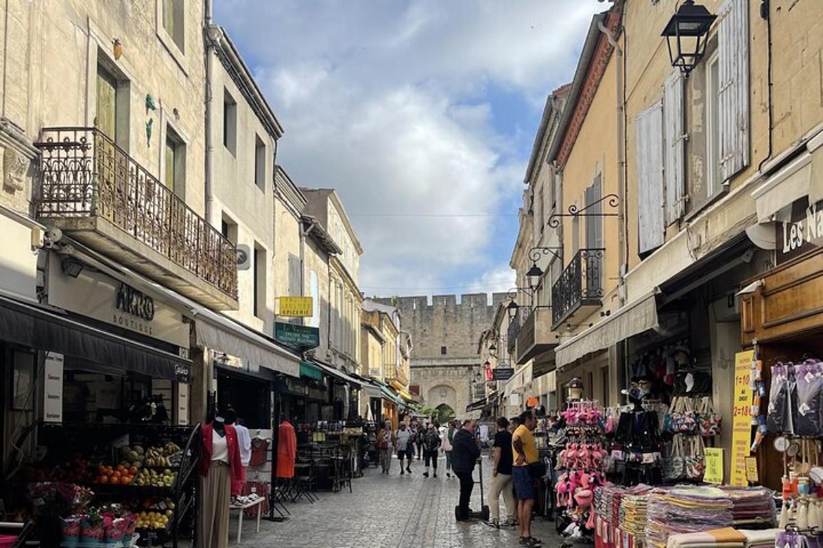 a group of people walking down a street with shops