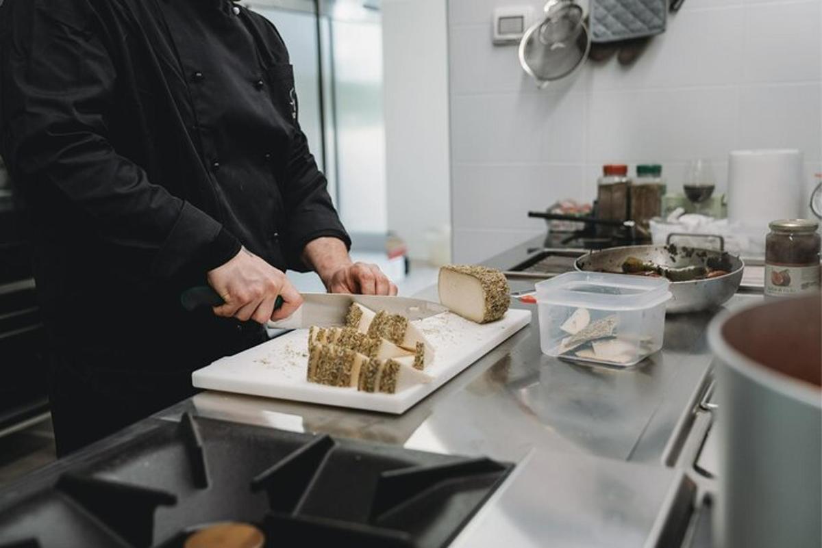 a man preparing food on a cutting board in a kitchen