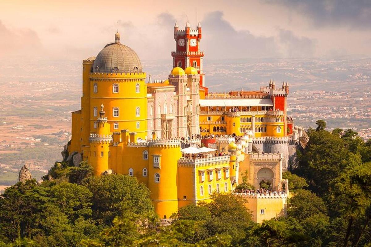 un castel galben mare pe vârful unui munte