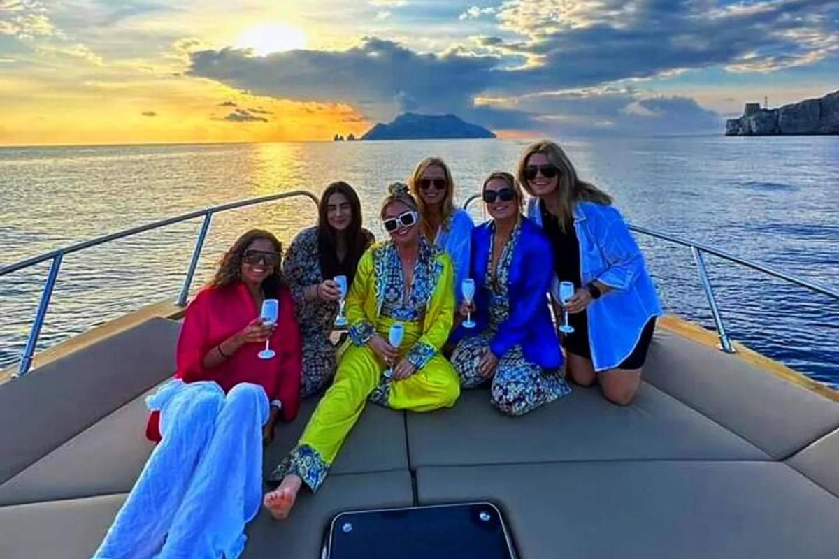 um grupo de mulheres sentadas na parte de trás de um barco