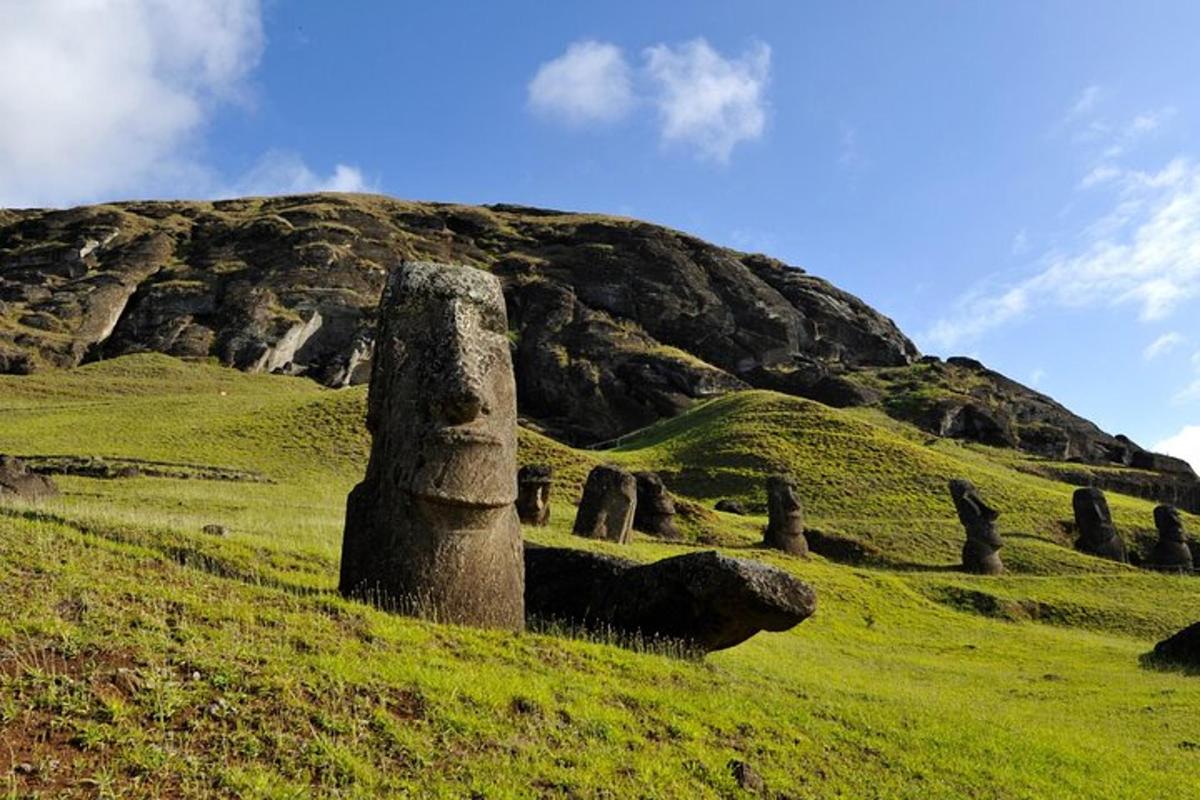 a grassy hill with a large rock formation on it