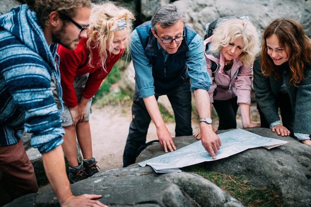 a group of people looking at a map on a rock
