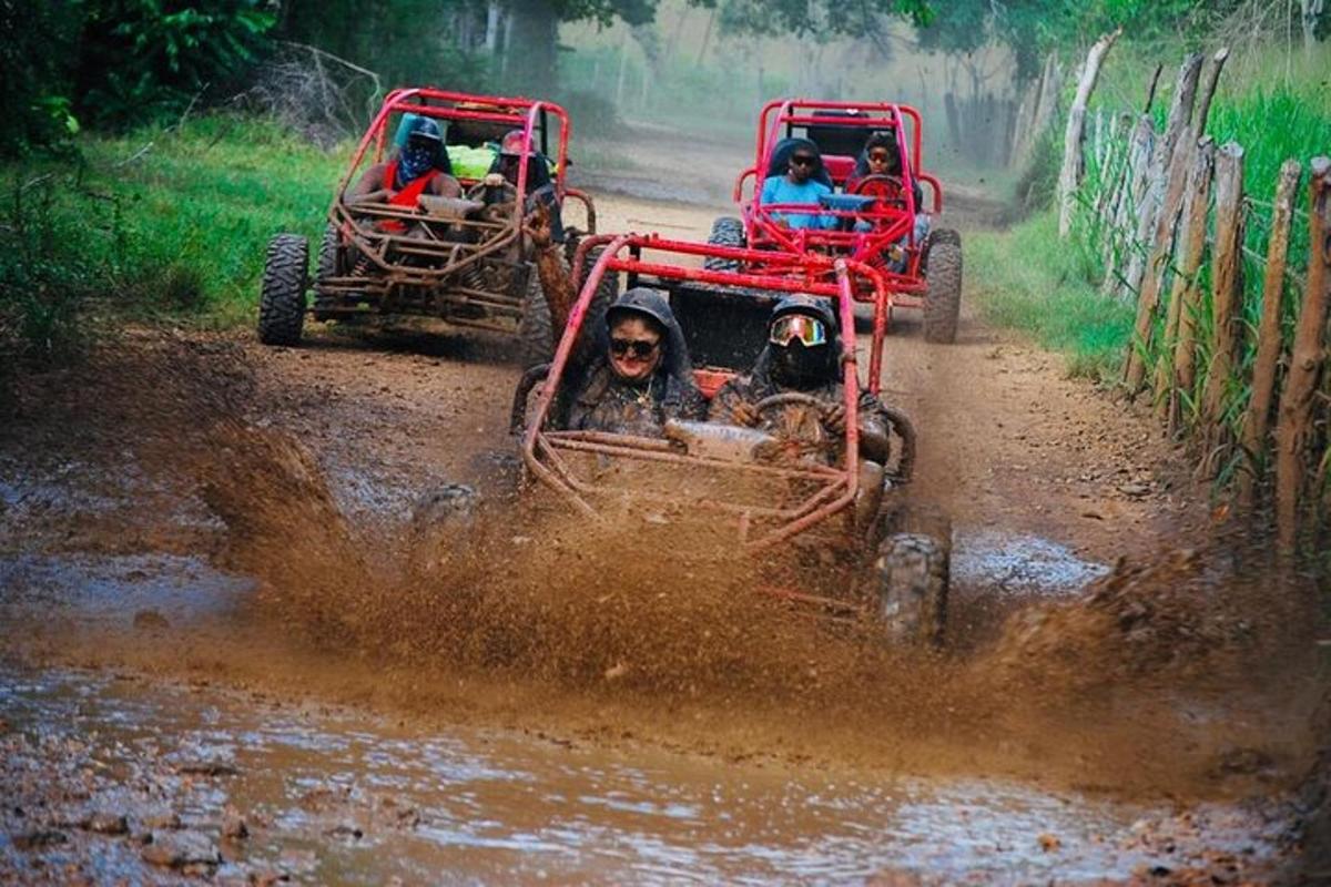 a group of people riding in jeeps in a muddy field