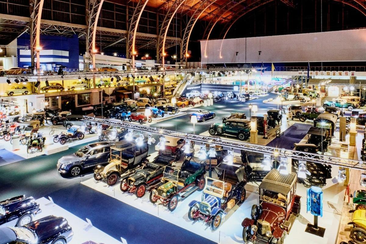 a large room filled with lots of cars on display
