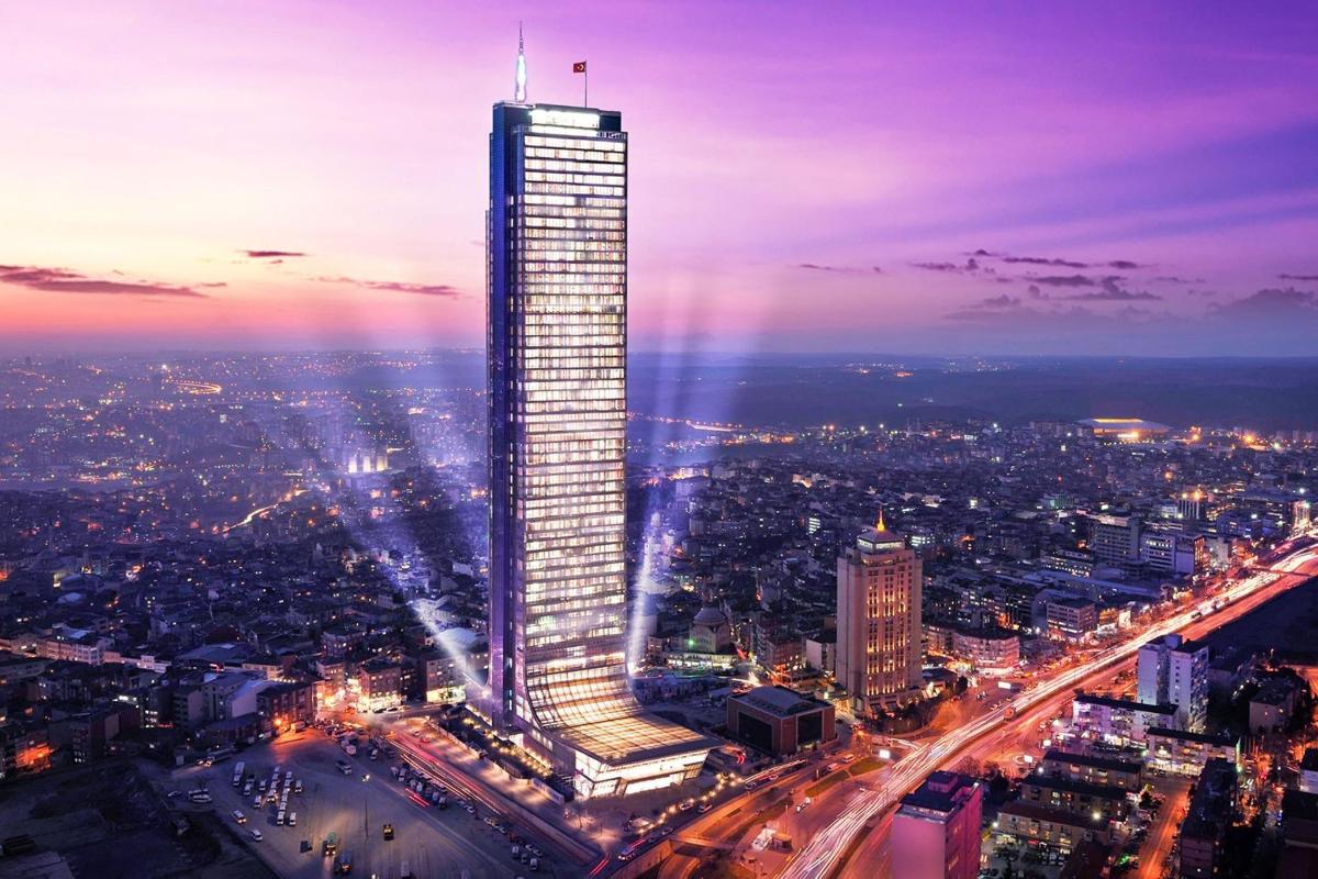 a lit up skyscraper in a city at night