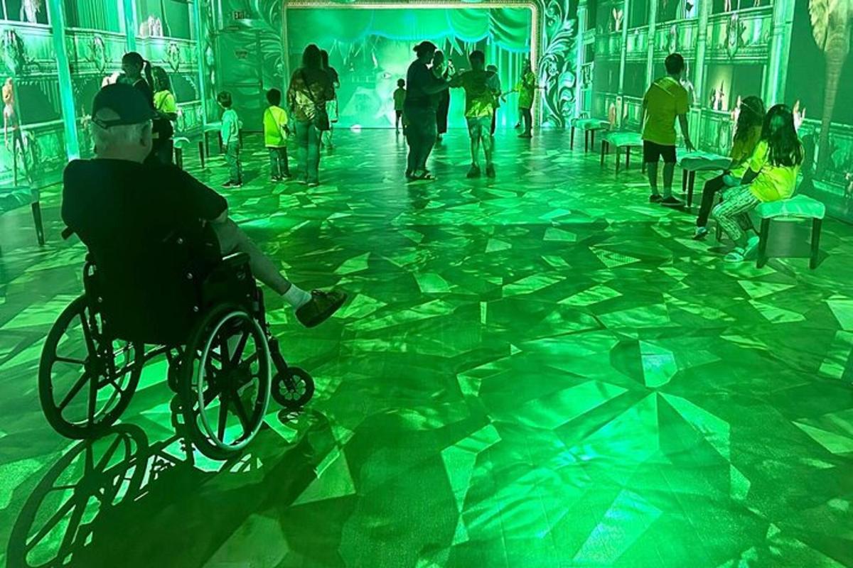 a man in a wheelchair in a room with a dance floor