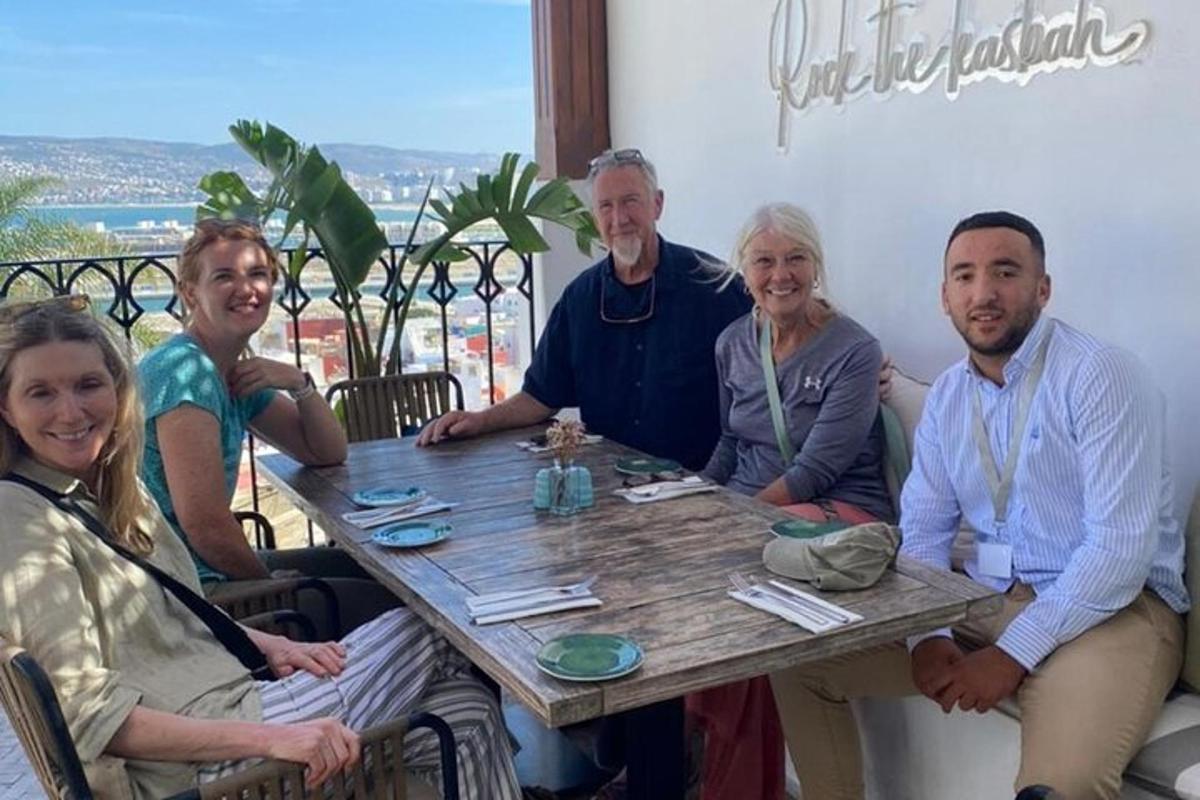 a group of people sitting around a wooden table