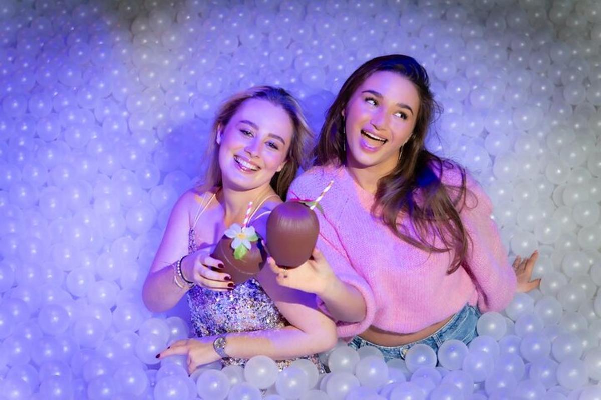 two girls are holding an ice cream in their hands