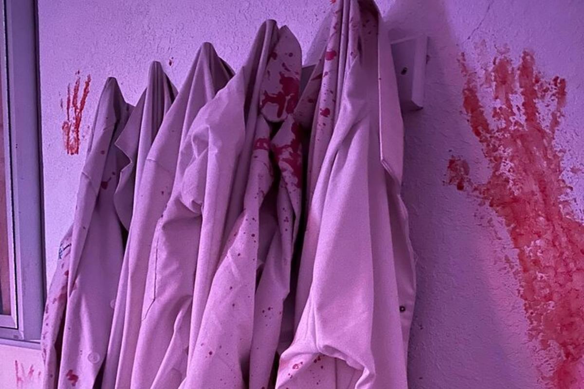 a pink towel hanging on a purple wall