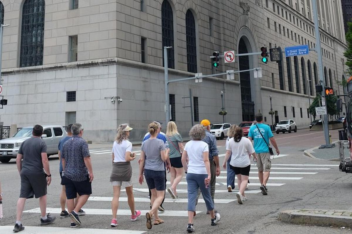 a group of people crossing a street at a crosswalk