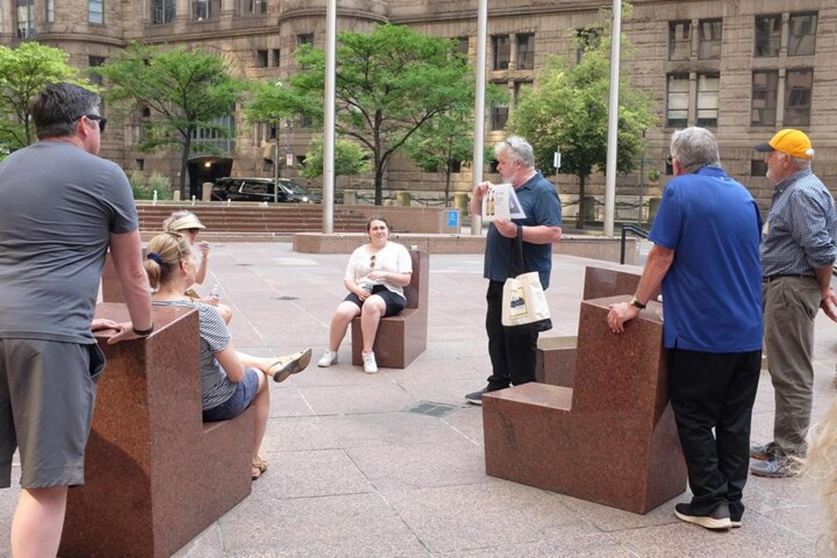 a group of people sitting in benches in front of a building