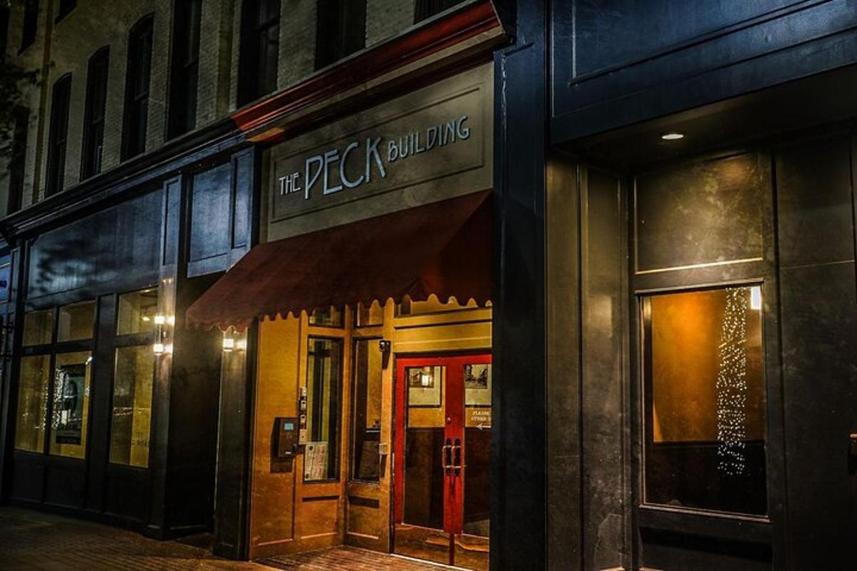 a facade of a pizza building with a red door