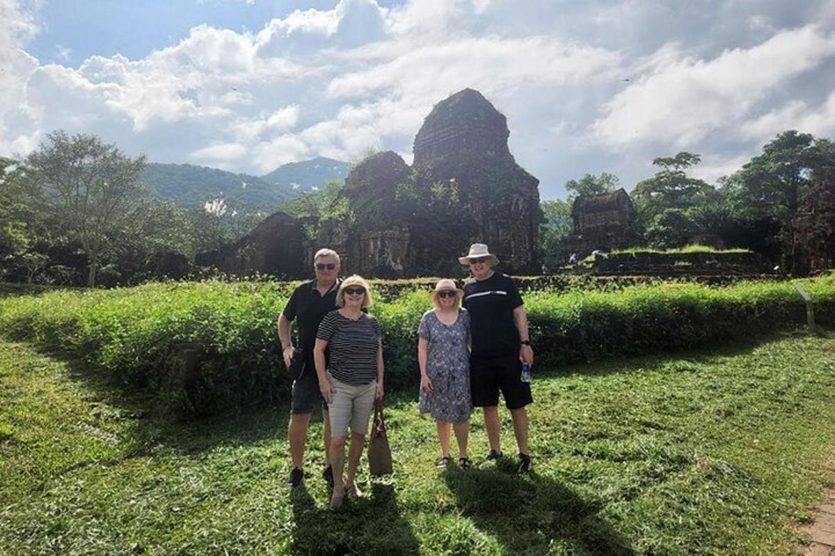 a family posing for a picture in front of a temple